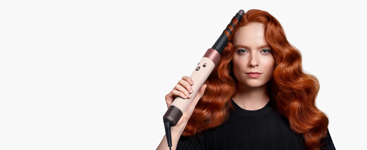 Model uses the Dyson Airwrap i.d. with the Conical Airwrap barrel attachment to style her hair.