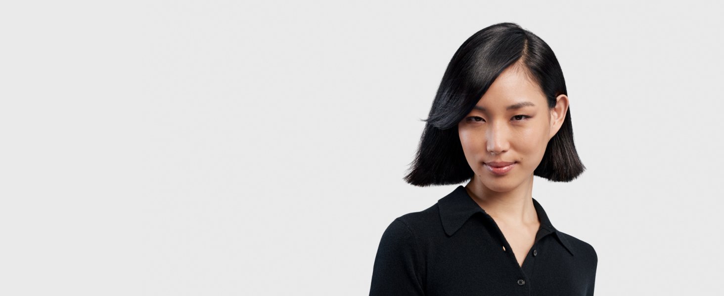 Model with black straight hair styled into a short sleek bob