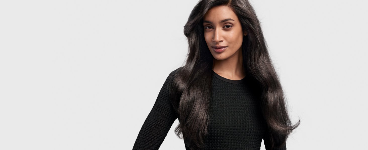 Model with dark hair styled into an iconic blowout